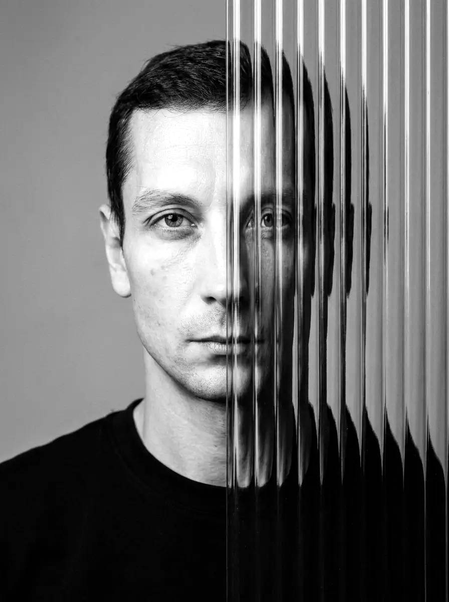 Vladimir Gorlanov — frontal portrait behind fluted glass with vertical lines